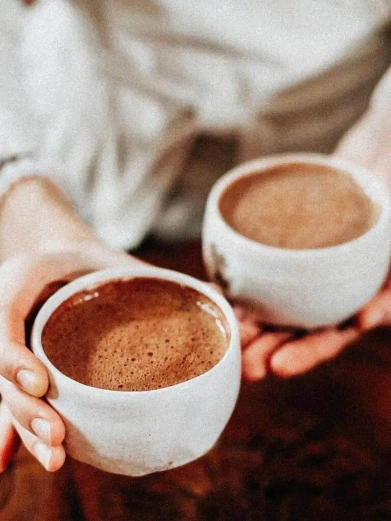 Twee koppen ceremoniële cacao worden gedeeld cacao ceremonie thuis of vrouwencirkel