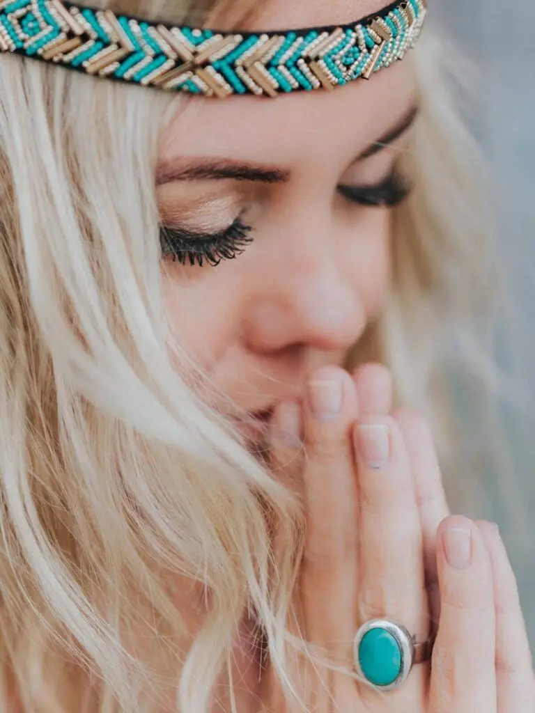 Vrouw met gesloten ogen en gevouwen handen, in meditatie met mini Choco Bliss